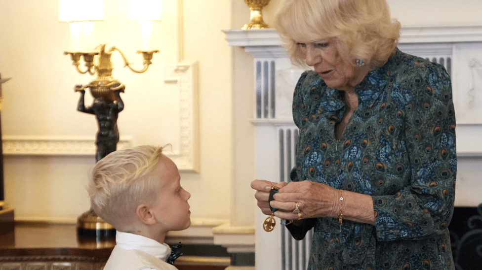 Queen Camilla Presents Commendation Medal to Seven-Year-Old Rupert Williams at Clarence House Tea Party